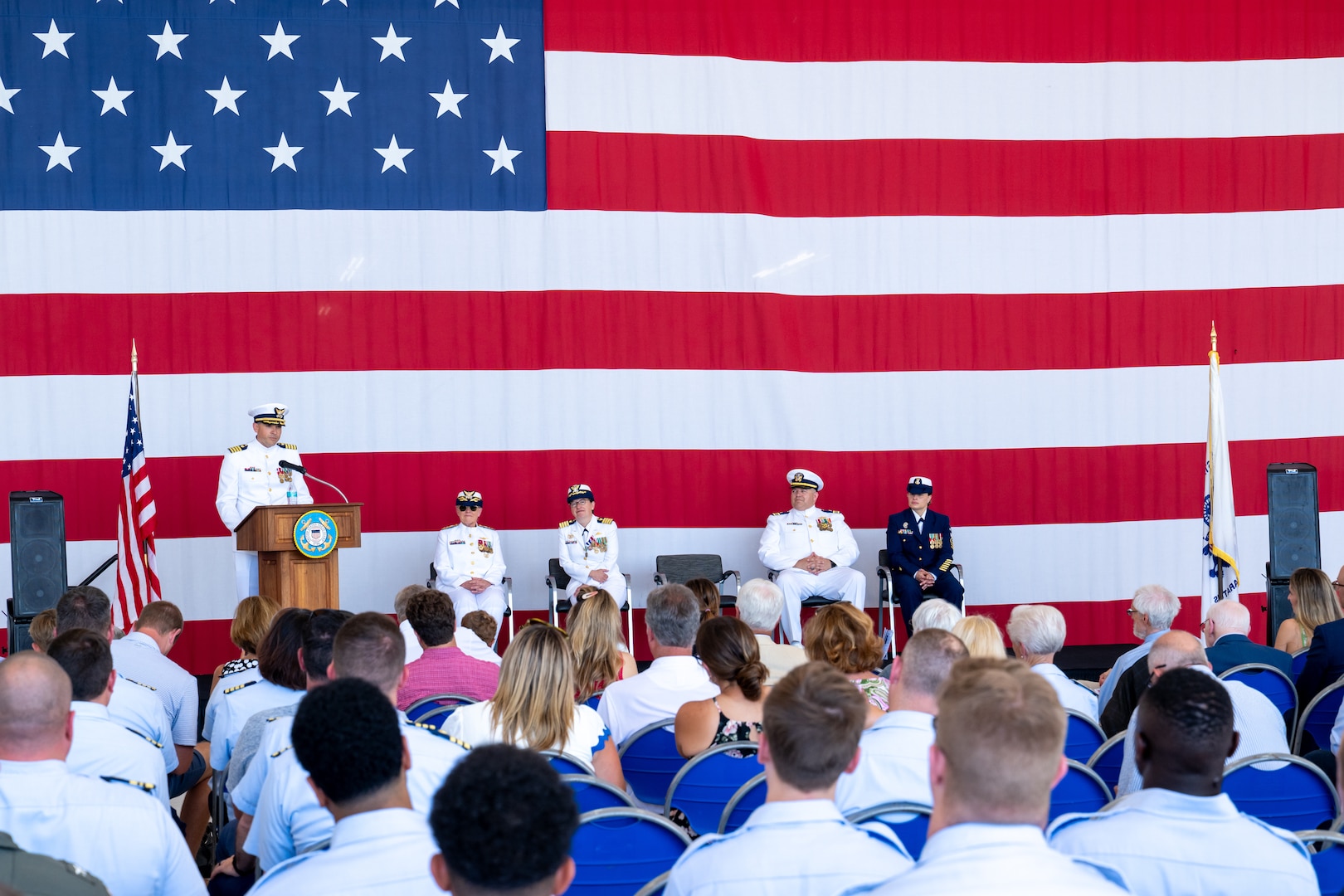 U.S. Coast Guard member speaks to a crowd.