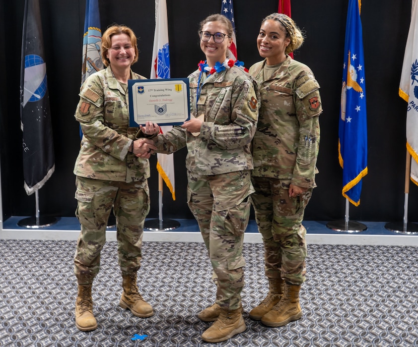 U.S. Air Force Tech. Sgt. select Danielle Anderegg, 17th Force Support Squadron, receives her Tech. Sgt. select certificate from Col. Angelina Maguinness, 17th Training Wing commander and Chief Master Sgt. Khamillia Washington, 17th TRW command chief at the Powell Event Center, Goodfellow Air Force Base, Texas, on June 27. The 2025 E6 cycle saw an overall selection rate of 25.62%, with 7,884 Airmen chosen for promotion.   (U.S. Air Force photo by Airman 1st Class James Salellas)