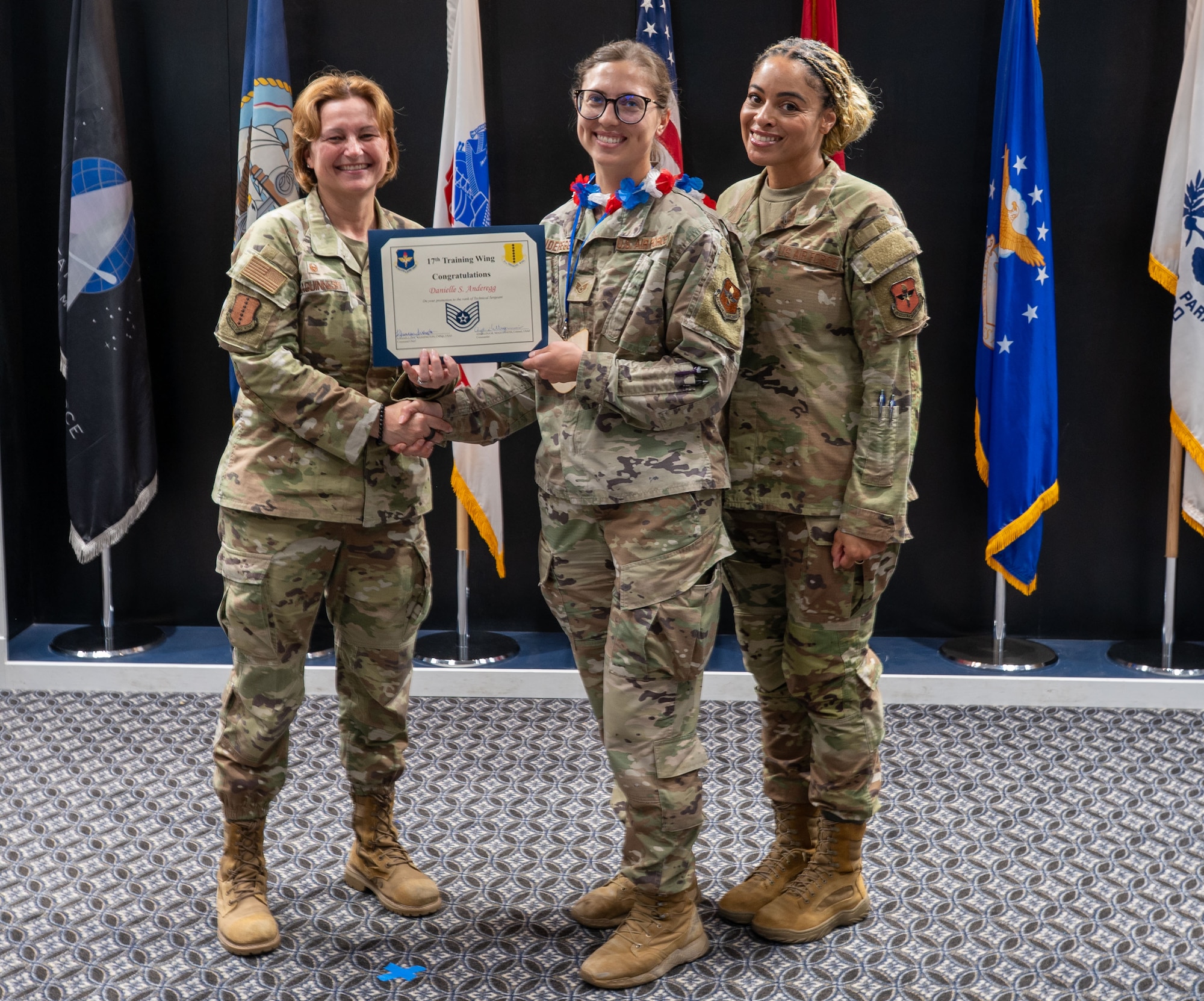 U.S. Air Force Tech. Sgt. select Danielle Anderegg, 17th Force Support Squadron, receives her Tech. Sgt. select certificate from Col. Angelina Maguinness, 17th Training Wing commander and Chief Master Sgt. Khamillia Washington, 17th TRW command chief at the Powell Event Center, Goodfellow Air Force Base, Texas, on June 27. The 2025 E6 cycle saw an overall selection rate of 25.62%, with 7,884 Airmen chosen for promotion.   (U.S. Air Force photo by Airman 1st Class James Salellas)