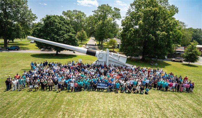The Naval Surface Warfare Center Dahlgren Division (NSWCDD) team gathered in front of the U.S. Navy 16-inch battleship gun on the parade field at the NSWCDD Command Picnic June 3. (Matt Lyman/NSWCDD photo)