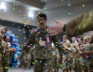 U.S. Air Force Tech. Sgt. select Ryan Patrick Torres, 316th Training Squadron, walks down the aisle as he prepares to receive his Tech. Sgt. Select certificate at the Powell Event Center, Goodfellow Air Force Base, Texas, on June 27. The average time in grade for selectees was just over five years, with a total service of approximately a decade. (U.S. Air Force photo by Senior Airman Evelyn J. D’Errico)