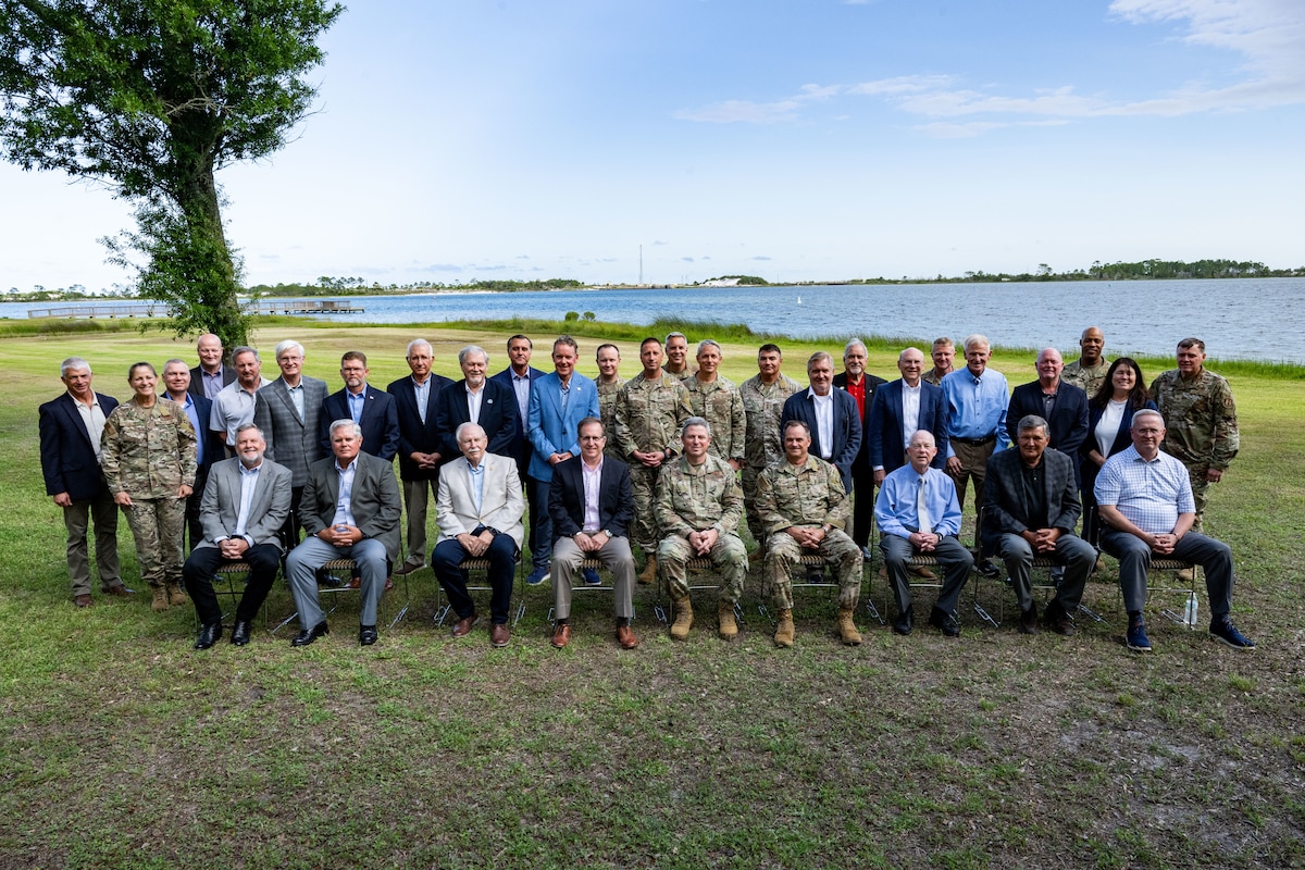 A group of current and former AFSOC senior leaders pose for a photo.