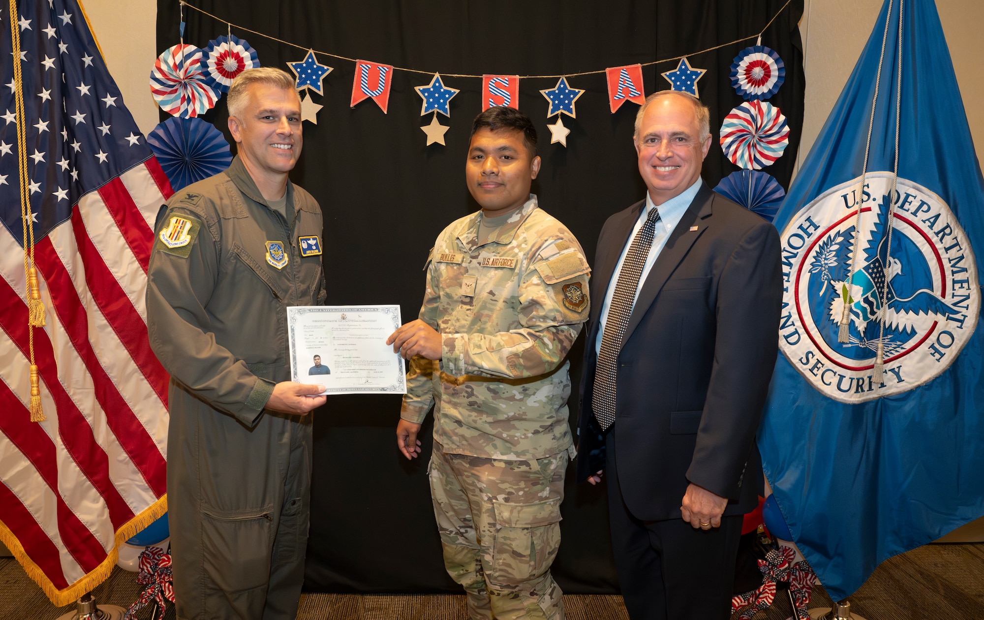 Airman poses for photo with people