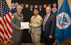 Airman poses for photo with people