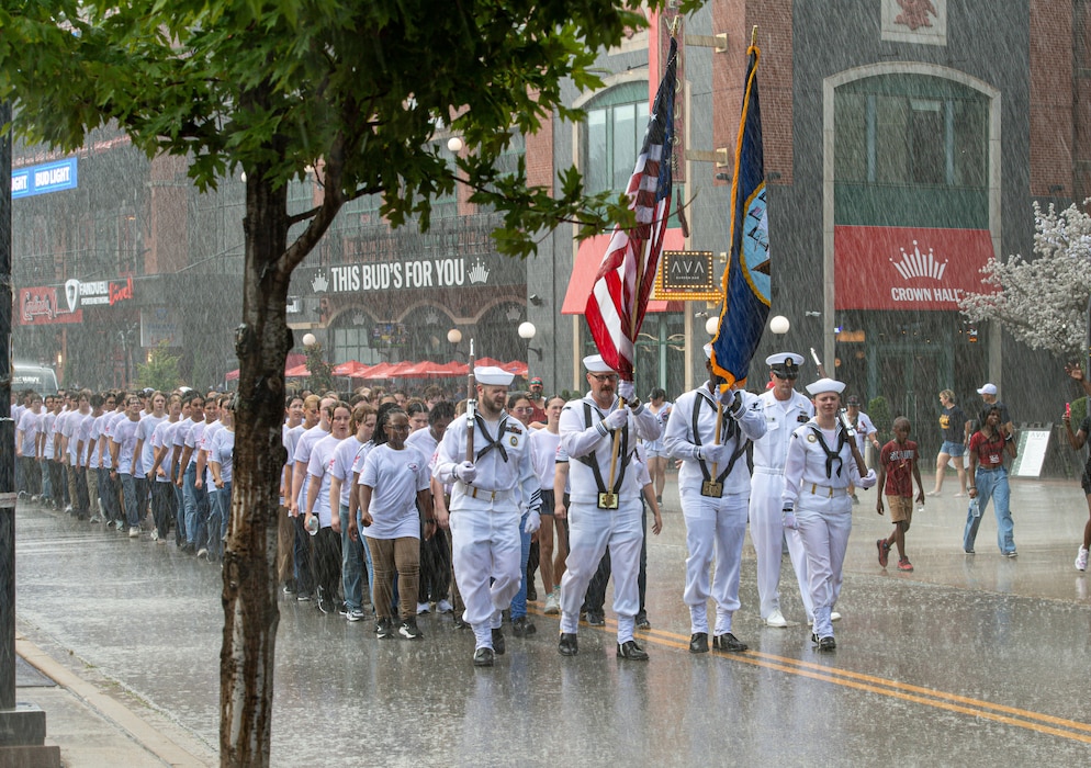 Future Sailors and Navy recruiters with NTAG Mid-America march through Ballpark Village to Busch Stadium for a Navy appreciation event, highlighting the Navy’s dedication to forging strong community and recruit connections.
