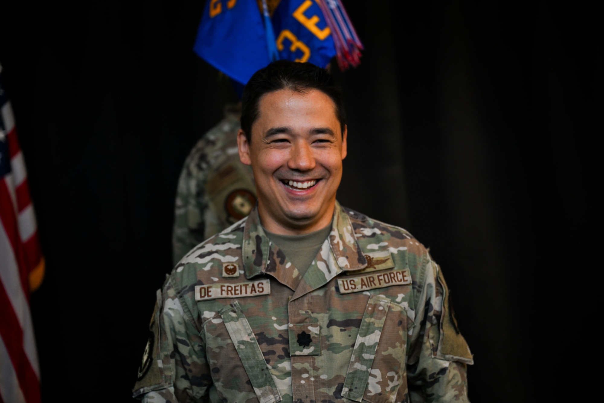 U.S. Air Force Lt. Col. Adrian De Freitas, 563d Electronic Warfare Squadron commander, smiles after taking command of the squadron during a change of command ceremony in San Antonio, Texas, June 30, 2025. The 563 EWS serves as a software development training arm, enabling others with best practices and techniques to secure electromagnetic spectrum superiority (U.S. Air Force photo by Capt. Benjamin Aronson)