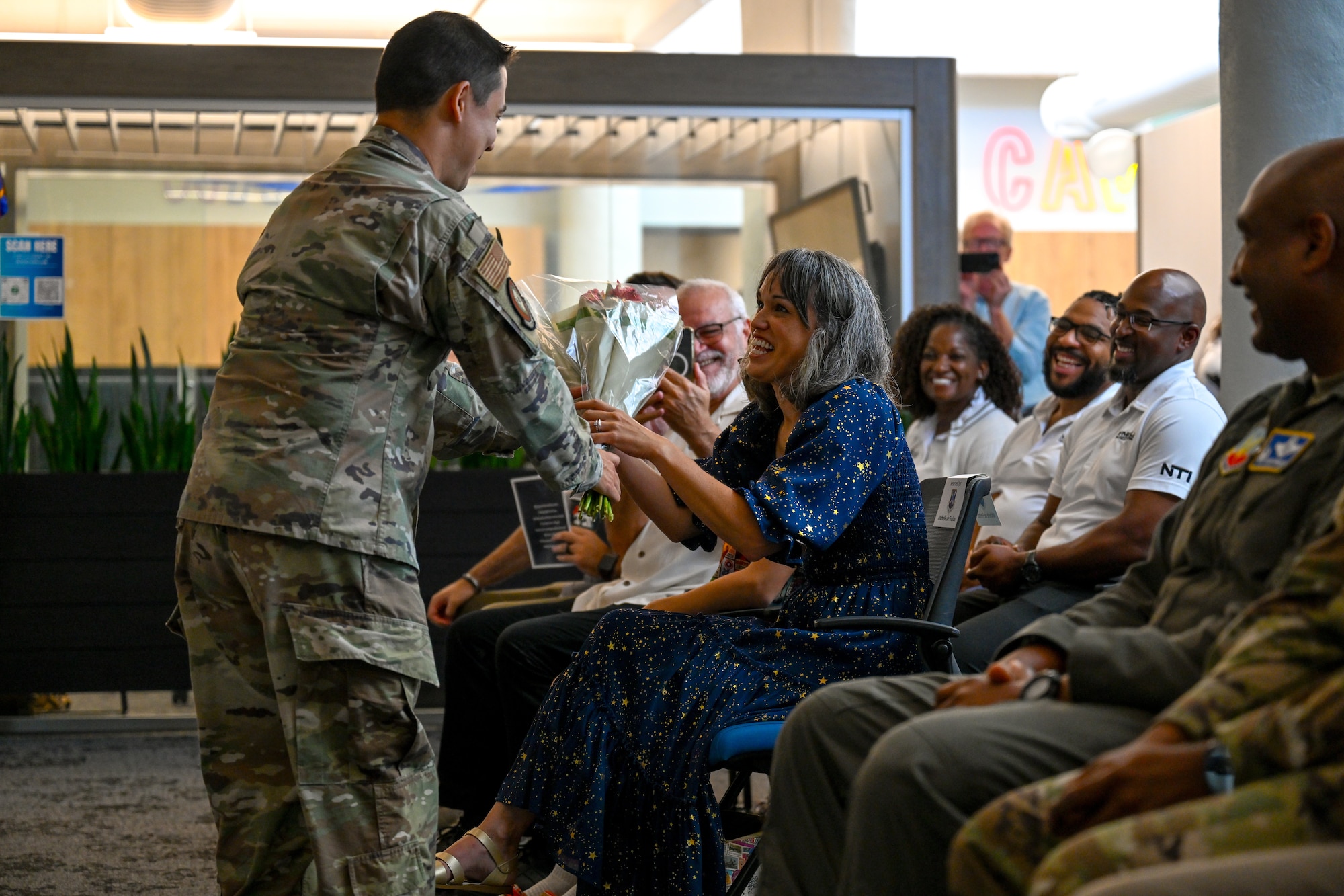 U.S. Air Force Lt. Col. Adrian De Freitas, 563d Electronic Warfare Squadron commander presents his wife with flowers after he took command during a change of command ceremony in San Antonio, Texas, June 30, 2025. The 563 EWS serves as a software development training arm, enabling others with best practices and techniques to secure electromagnetic spectrum superiority (U.S. Air Force photo by Capt. Benjamin Aronson)