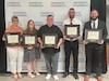 Photo of graduates posing with certificates