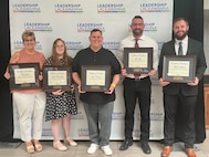 Photo of graduates posing with certificates