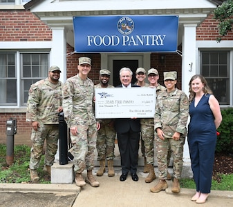 Leaders of Joint Base Anacostia-Bolling and the 11th Wing gather for a group photo with partners from the Air and Space Association during the opening of the base’s food pantry at JBAB, Washington, D.C., June 16, 2025.