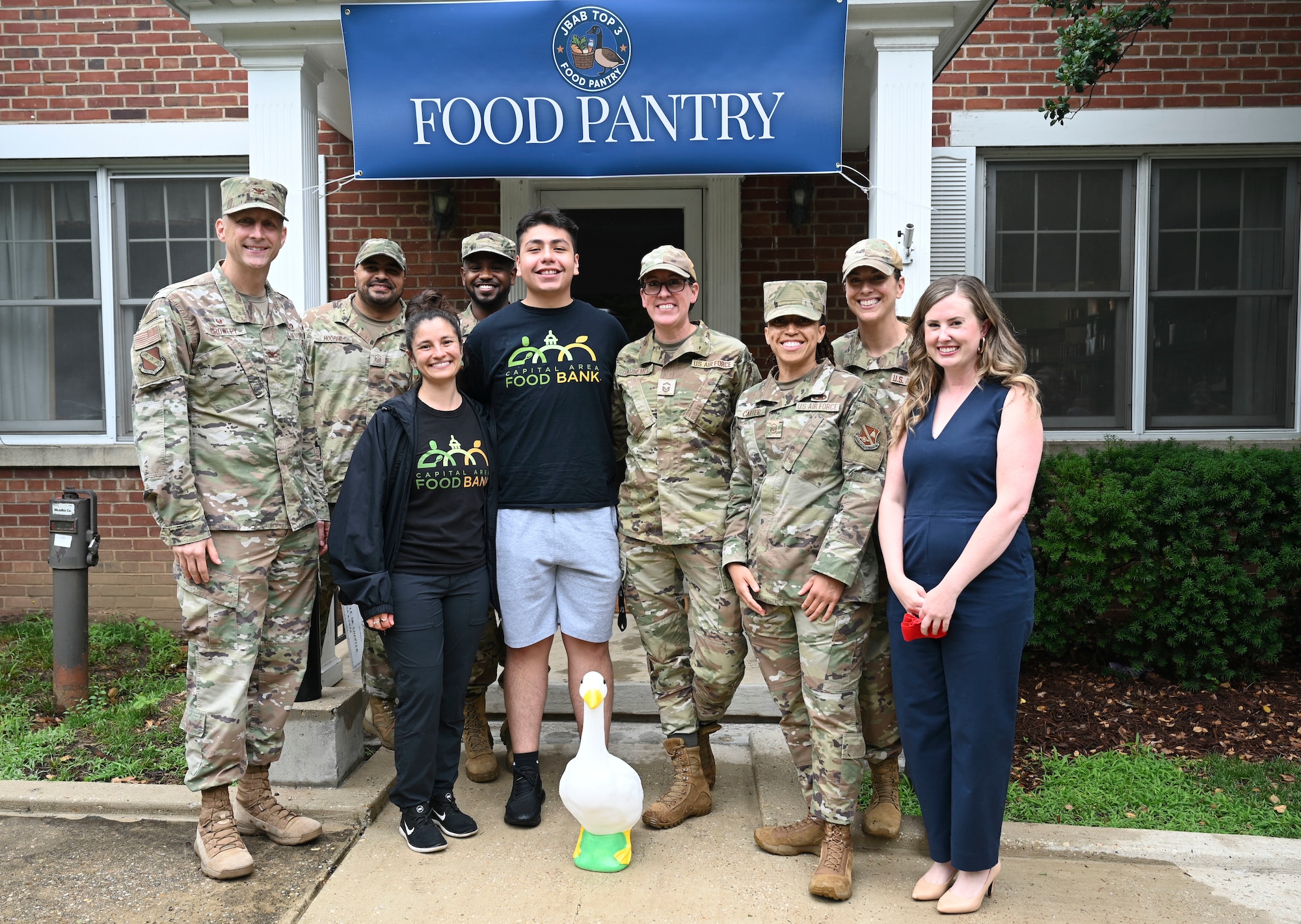 Leaders of Joint Base Anacostia-Bolling and the 11th Wing gather for a group photo with partners from the Capital Area Food Bank during the opening of the base’s food pantry at JBAB, Washington, D.C., June 16, 2025.