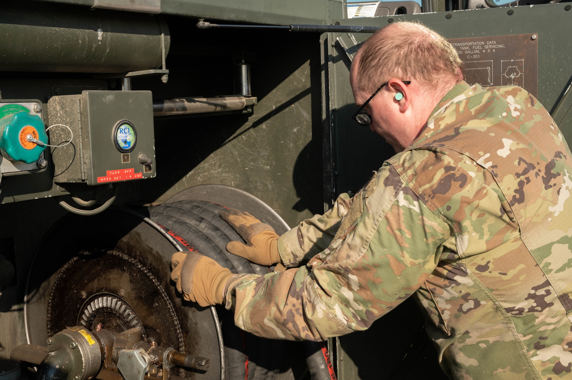 Senior Airman Kenneth Taylor, 5th Logistics Readiness Squadron petroleum, oil and lubricant flight (POL) fuels expeditor, stores a C-300 mobile fuel vehicle’s fuel pump hose after refueling forklifts at Minot Air Force Base, North Dakota, June 24, 2025. POL manages, maintains and distributes fuel to aircraft and other vehicles on base ensuring mission continuity. (U.S. Air Force photo by Airman 1st Class Wesley Davies)