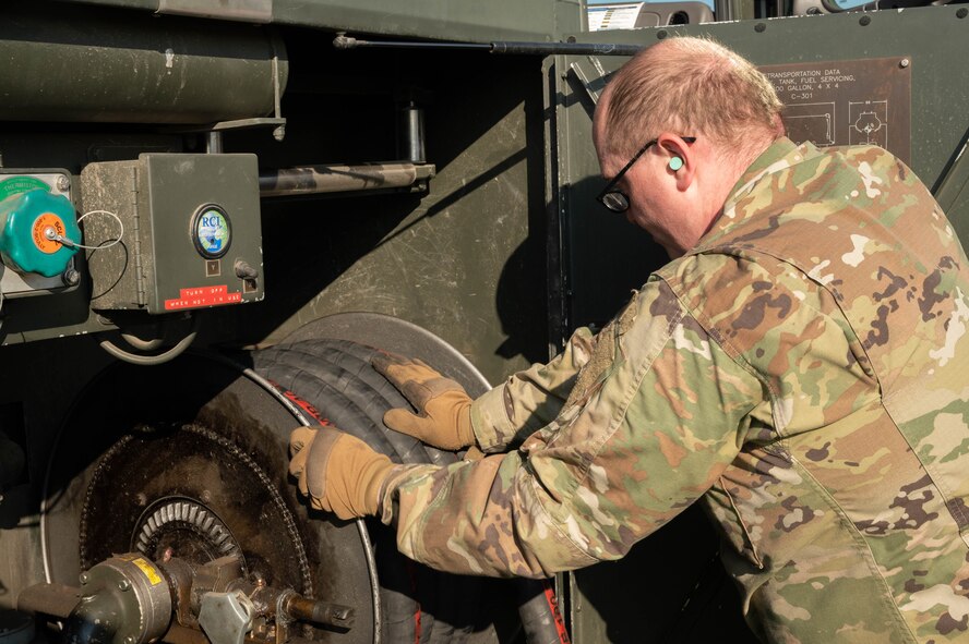 Senior Airman Kenneth Taylor, 5th Logistics Readiness Squadron petroleum, oil and lubricant flight (POL) fuels expeditor, stores a C-300 mobile fuel vehicle’s fuel pump hose after refueling forklifts at Minot Air Force Base, North Dakota, June 24, 2025. POL manages, maintains and distributes fuel to aircraft and other vehicles on base ensuring mission continuity. (U.S. Air Force photo by Airman 1st Class Wesley Davies)