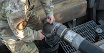 Senior Airman Tristan Turkovitz, 5th Logistics Readiness Squadron petroleum, oil and lubricant flight fuels expeditor, detaches an R-12 hydrant refueling truck fuel pump hose from a type III hydrant system after defueling a B-52H Stratofortress at Minot Air Force Base, North Dakota, June 24, 2025. The R-12 hydrant refueling truck is capable of displacing 1,000 gallons of fuel per minute through two platform hoses to either refuel or defuel an aircraft. (U.S. Air Force photo by Airman 1st Class Wesley Davies)