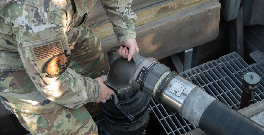 Senior Airman Tristan Turkovitz, 5th Logistics Readiness Squadron petroleum, oil and lubricant flight fuels expeditor, detaches an R-12 hydrant refueling truck fuel pump hose from a type III hydrant system after defueling a B-52H Stratofortress at Minot Air Force Base, North Dakota, June 24, 2025. The R-12 hydrant refueling truck is capable of displacing 1,000 gallons of fuel per minute through two platform hoses to either refuel or defuel an aircraft. (U.S. Air Force photo by Airman 1st Class Wesley Davies)