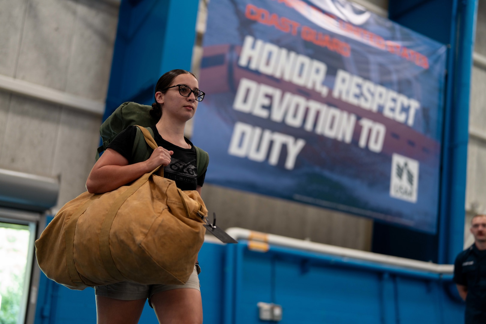 A U.S. Coast Guard Academy (USCGA) swab enters Roland Hall during Day One at USCGA, New London, Connecticut, June 30, 2025. Day One marks the start of Swab Summer, an intensive seven-week program that prepares students for military and Academy life. (U.S. Coast Guard photo by Petty Officer 3rd Class Matt Thieme)