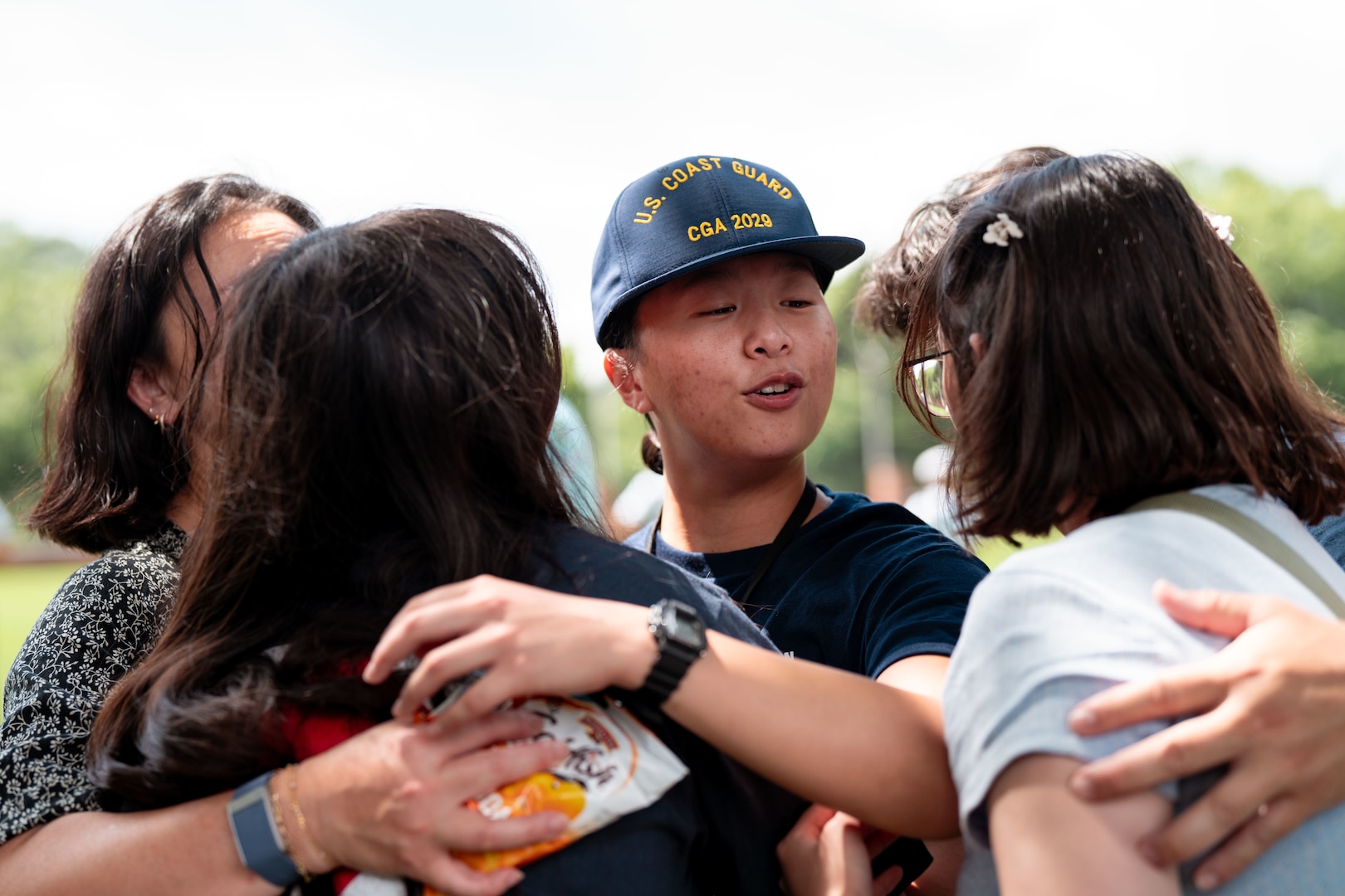 A U.S. Coast Guard Academy (USCGA) swab from the Class of 2029 embraces a loved one during Day One at USCGA, New London, Connecticut, June 30, 2025. The new Class of 2029 are given 15 minutes to say goodbye to their families before they enter the seven-week training environment. (U.S. Coast Guard photo by Petty Officer 3rd Class Matt Thieme.)