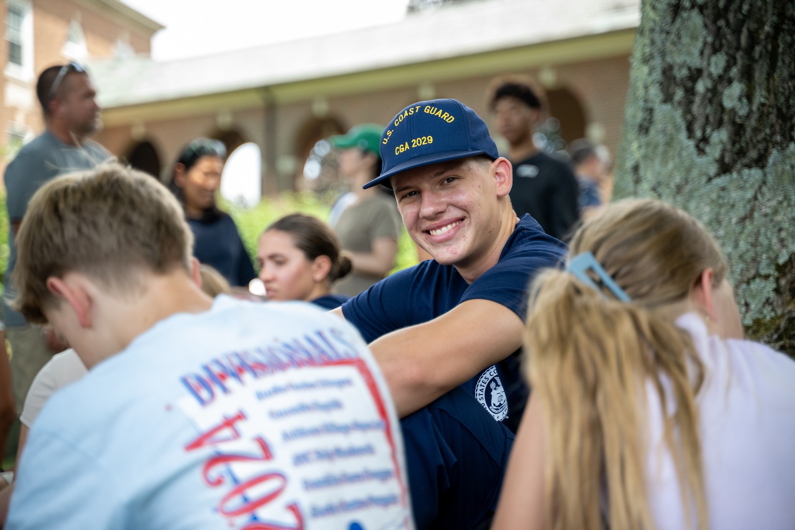 U.S. Coast Guard Academy (USCGA) swab from the Class of 2029 sits with loved ones during Day One at USCGA, New London, Connecticut, June 30, 2025. The new Class of 2029 are given 15 minutes to say goodbye to their families before they enter the seven-week training environment. (U.S. Coast Guard photo by Petty Officer Third Class Leo Avila.)