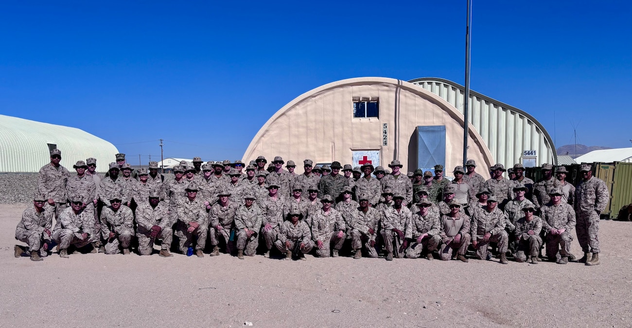 Corpsmen from across the Navy gather for a group photo during Integrated Training Exercise (ITX) at Marine Corps Air Ground Combat Center Twentynine Palms in June. More than 70 corpsmen supported the 25th Marine Regiment throughout the 31-day exercise, providing critical medical care during live-fire ranges, treating both simulated and real-world casualties, and ensuring the health and readiness of Marines in austere field conditions (Courtesy photo).