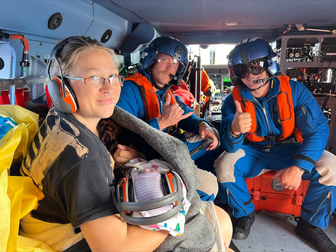 A mother and newborn await escort aboard a U.S. Coast Guard helicopter on Catalina Island, California, June 29, 2025. The medevac was performed to take them to a shoreside medical facility. (U.S. Coast Guard Courtesy Photo)