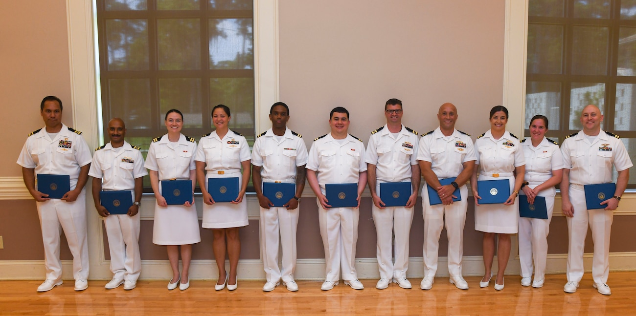 Graduating residents from Naval Medical Center Camp Lejeune's Family Medicine Residency Program pose with their certificates n June 27, 2025. The NMCCL Graduate Medical Education program graduated 11 family medicine residents and 10 family medicine interns, two sports medicine fellows, and one family medicine-obstetric fellow. The Family Medicine Residency Program accounts for nearly a one-quarter of all family medicine physicians in the Navy.