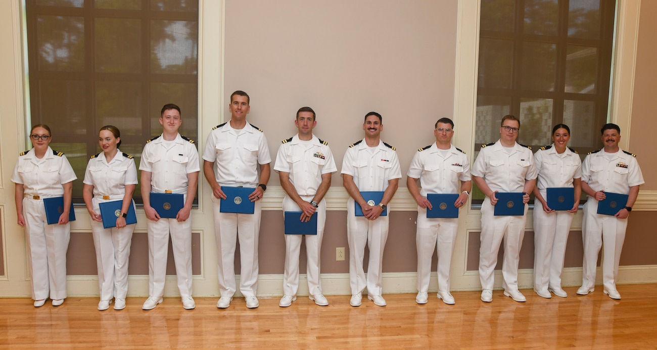 Graduating interns from Naval Medical Center Camp Lejeune's Family Medicine Residency Program pose with their certificates n June 27, 2025. The NMCCL Graduate Medical Education program graduated 11 family medicine residents and 10 family medicine interns, two sports medicine fellows, and one family medicine-obstetric fellow. The Family Medicine Residency Program accounts for nearly a one-quarter of all family medicine physicians in the Navy.