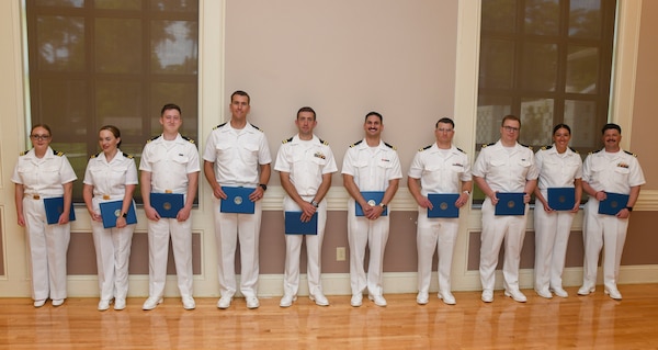 Graduating interns from Naval Medical Center Camp Lejeune's Family Medicine Residency Program pose with their certificates n June 27, 2025. The NMCCL Graduate Medical Education program graduated 11 family medicine residents and 10 family medicine interns, two sports medicine fellows, and one family medicine-obstetric fellow. The Family Medicine Residency Program accounts for nearly a one-quarter of all family medicine physicians in the Navy.