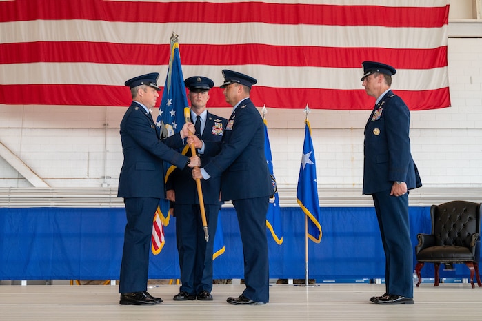 U.S. Air Force Lt. Gen. Michael Conley, commander Air Force Special Operations Command, passes the guidon to Col. Zach Blom, incoming commander of the 492nd SOW, during a change of command ceremony at Hurlburt Field, Florida, June 27, 2025.