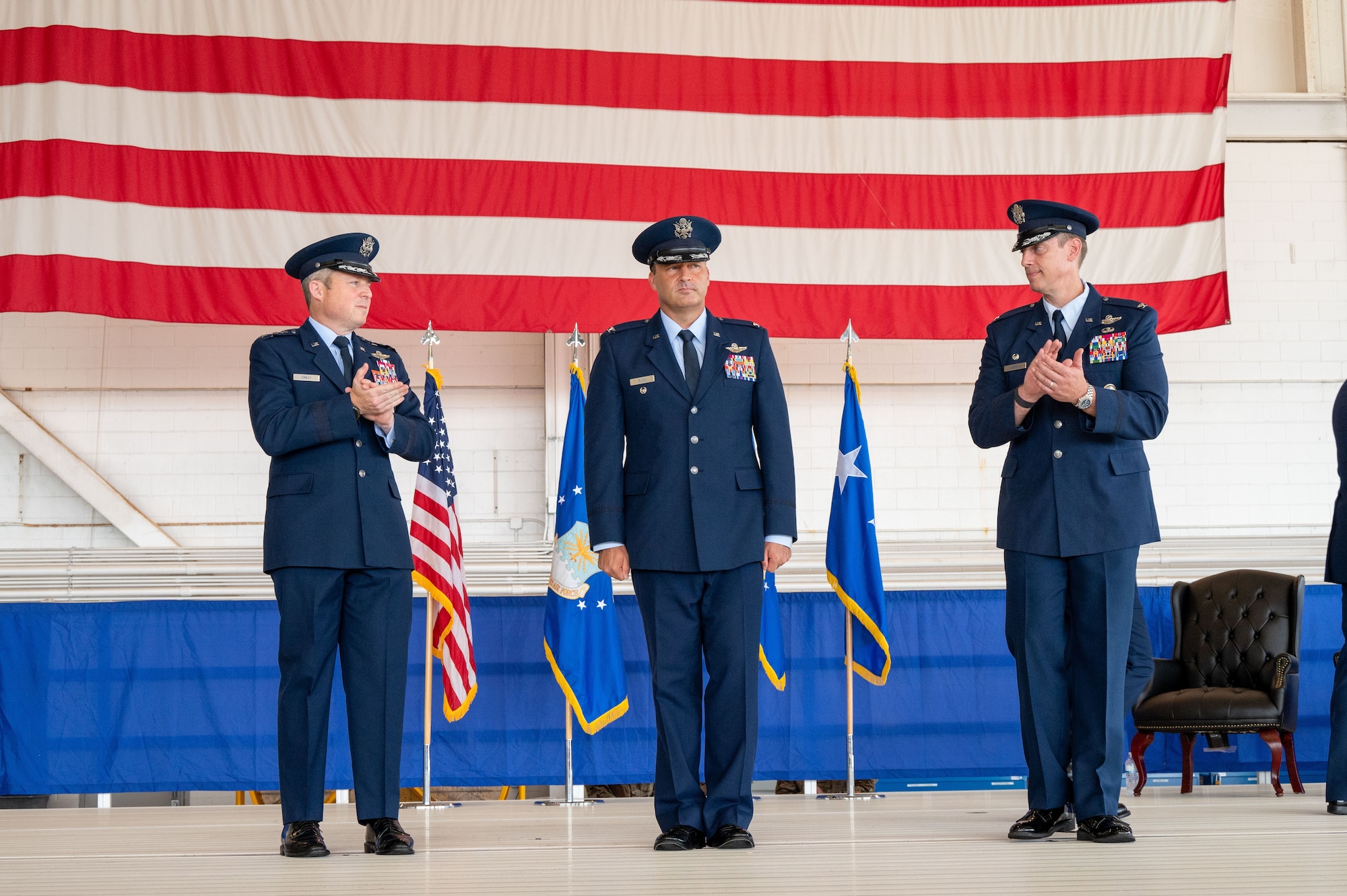 U.S. Air Force Lt. Gen. Michael Conley, left, commander Air Force Special Operations Command, applauds Col. Zach Blom, center, incoming 492nd Special Operations Wing commander, alongside Col. Patrick Wnetrzak, right, outgoing 492nd SOW commander during a change of command ceremony at Hurlburt Field, Florida, June 27, 2025
