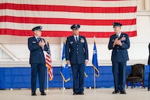 U.S. Air Force Lt. Gen. Michael Conley, left, commander Air Force Special Operations Command, applauds Col. Zach Blom, center, incoming 492nd Special Operations Wing commander, alongside Col. Patrick Wnetrzak, right, outgoing 492nd SOW commander during a change of command ceremony at Hurlburt Field, Florida, June 27, 2025