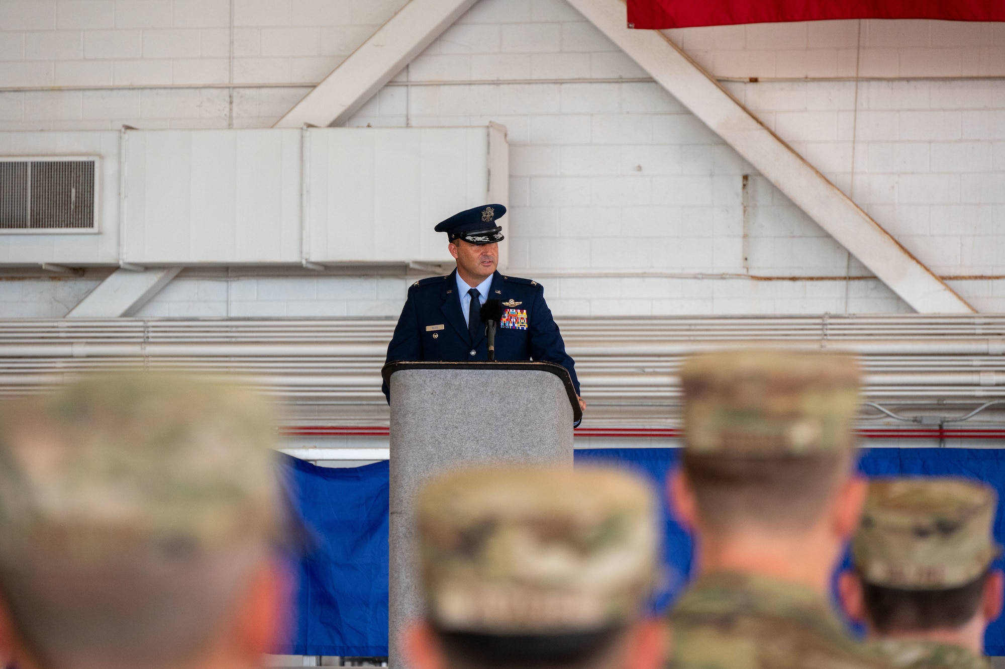 U.S. Air Force Colonel Zak Blom speaks to audience during a change of command ceremony.