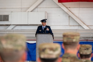 U.S. Air Force Colonel Zak Blom speaks to audience during a change of command ceremony.
