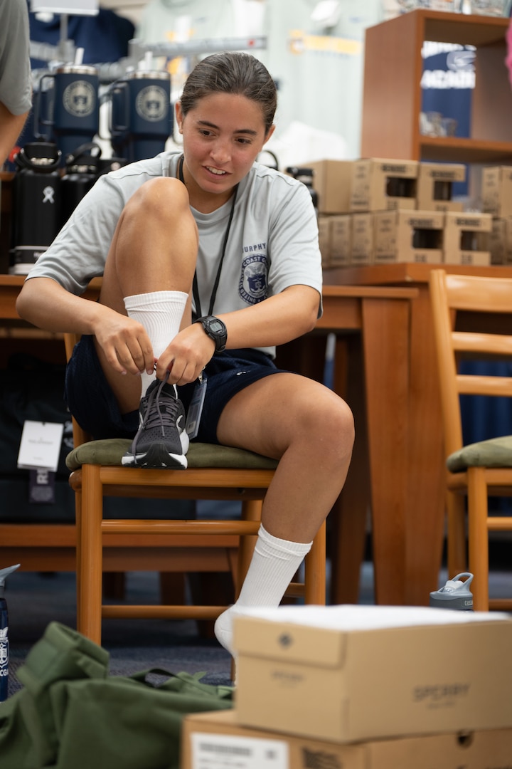U.S. Coast Guard Academy (USCGA) Class of 2029  try on shoes during Day One uniat USCGA, New London, Connecticut, June 30, 2025. Day One is the start of Swab Summer, an intensive seven-week program that transforms swabs into cadets. (U.S. Coast Guard photo by Petty Officer Second Class Janessa Warschkow.)