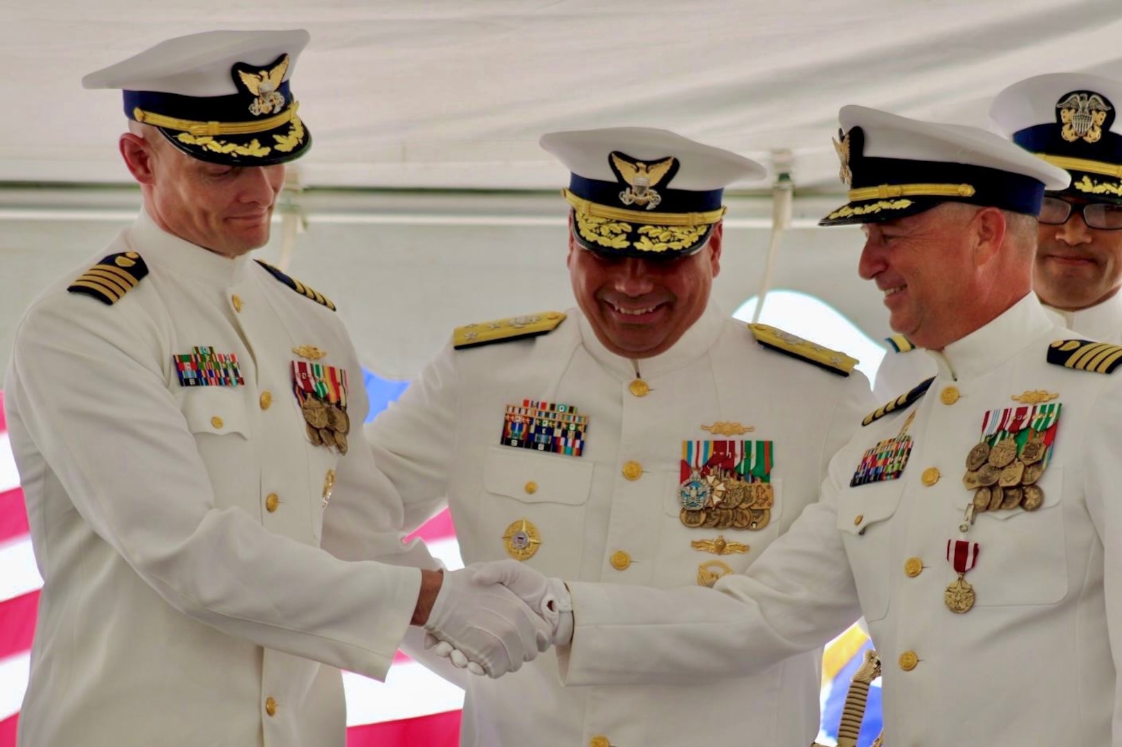 Capt. Robert Kinsey (left) shakes hands with Capt. Craig Allen (right) during the U.S. Coast Guard Cutter Kimball’s (WMSL 756) change of command ceremony in Honolulu, June 27, 2025.  Allen relieved Kinsey as Kimball’s commanding officer during the ceremony presided over by Vice Adm. Andrew Tiongson, commander of U.S. Coast Guard Pacific Area. U.S. Coast Guard photo by Ensign Sean Dreher.