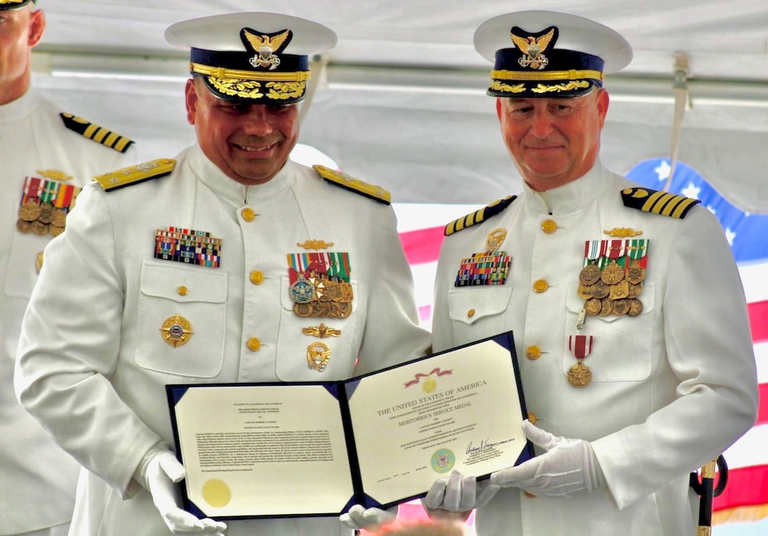 Vice Adm. Andrew Tiongson (left), commander of U.S. Coast Guard Pacific Area, presents a Meritorious Service Medal to Capt. Robert Kinsey (right) during the U.S. Coast Guard Cutter Kimball’s (WMSL 756) change of command ceremony in Honolulu, June 27, 2025. Kinsey served as Kimball’s commanding officer from July 2023 to June 2025 and led Kimball’s crew on deployments to the Eastern Pacific for a counter-drug patrol and to the Bering Sea in support of fisheries enforcement and providing a military presence protecting U.S. interests within the U.S. Exclusive Economic Zone. U.S. Coast Guard photo by Ensign Sean Dreher.