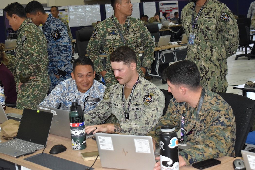 U.S. Marine Corps Maj. David Miller (right), the current operations officer with Marine Rotational Force – Darwin 25.3, conducts planning with his Navy and Malaysian Armed Forces counterparts at the Joint Warfighting Center, Kuantan, Malaysia, June 20, 2025.