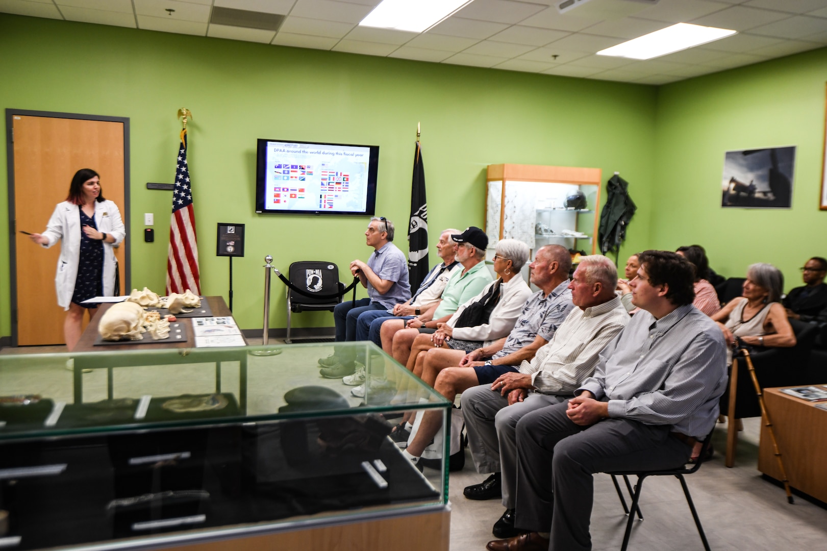 Dr. Katie East, forensic anthropologist with the Defense POW/MIA Accounting Agency, briefs family members of fallen service members before a tour of the DPAA laboratory, June 25, 2025 at Offutt Air Force Base, Nebraska.