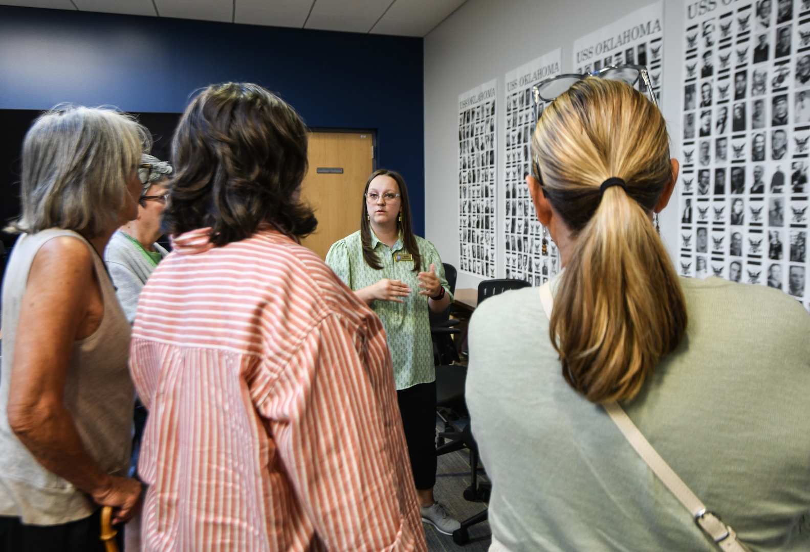 Emily Paulson, case coordinator with the Defense POW/MIA Accounting Agency, speaks with family members of fallen service members during a tour of the DPAA laboratory, June 25, 2025 at Offutt Air Force Base, Nebraska.