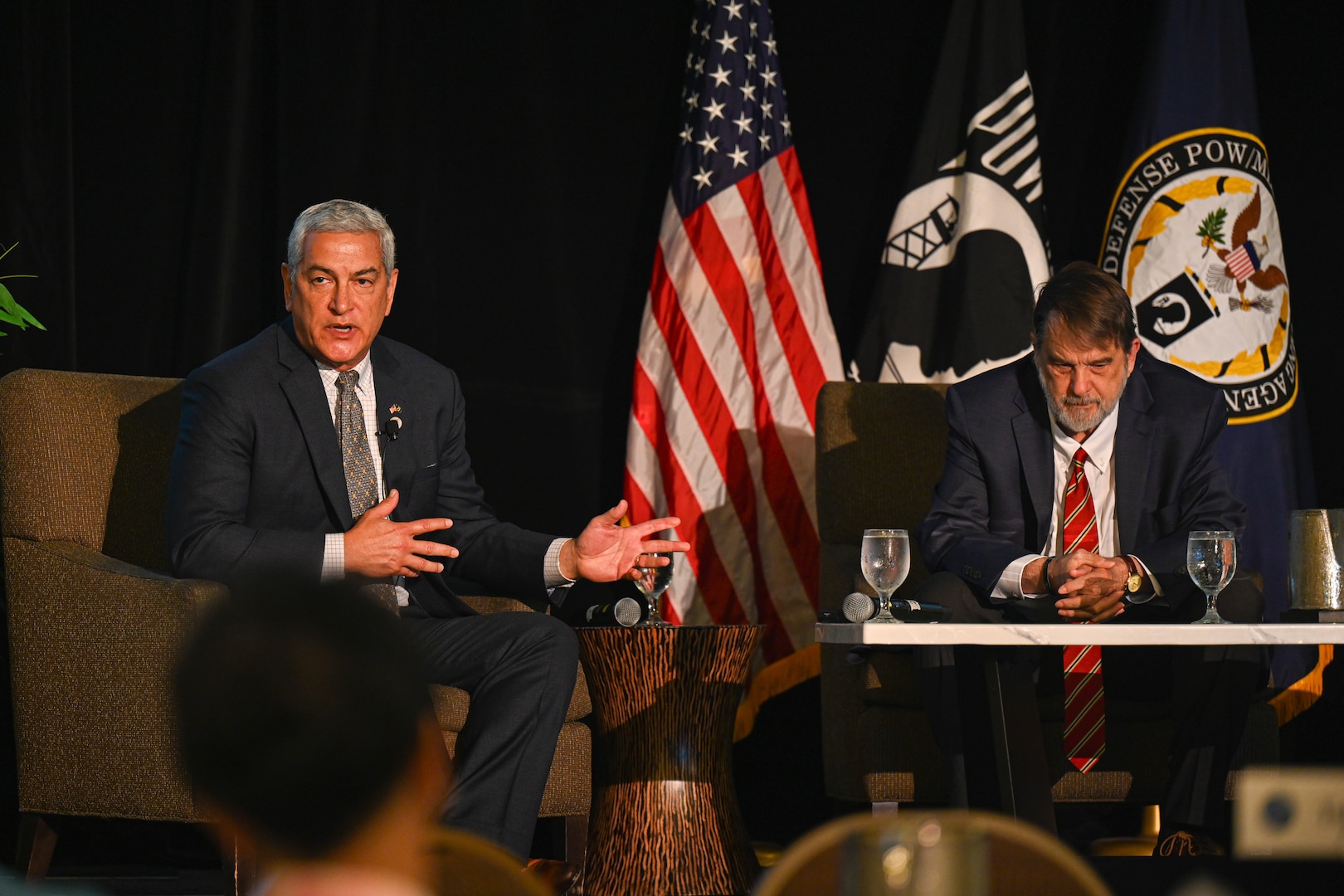 Kelly McKeague, Defense POW/MIA Accounting Agency director, left, and Dr. Tom Holland, research professor and director of the Forensic Institute for Research and Education at Middle Tennessee State University, right, give a brief at the Vietnam War Annual Government Briefing, Omaha, Nebraska, June 26, 2025.