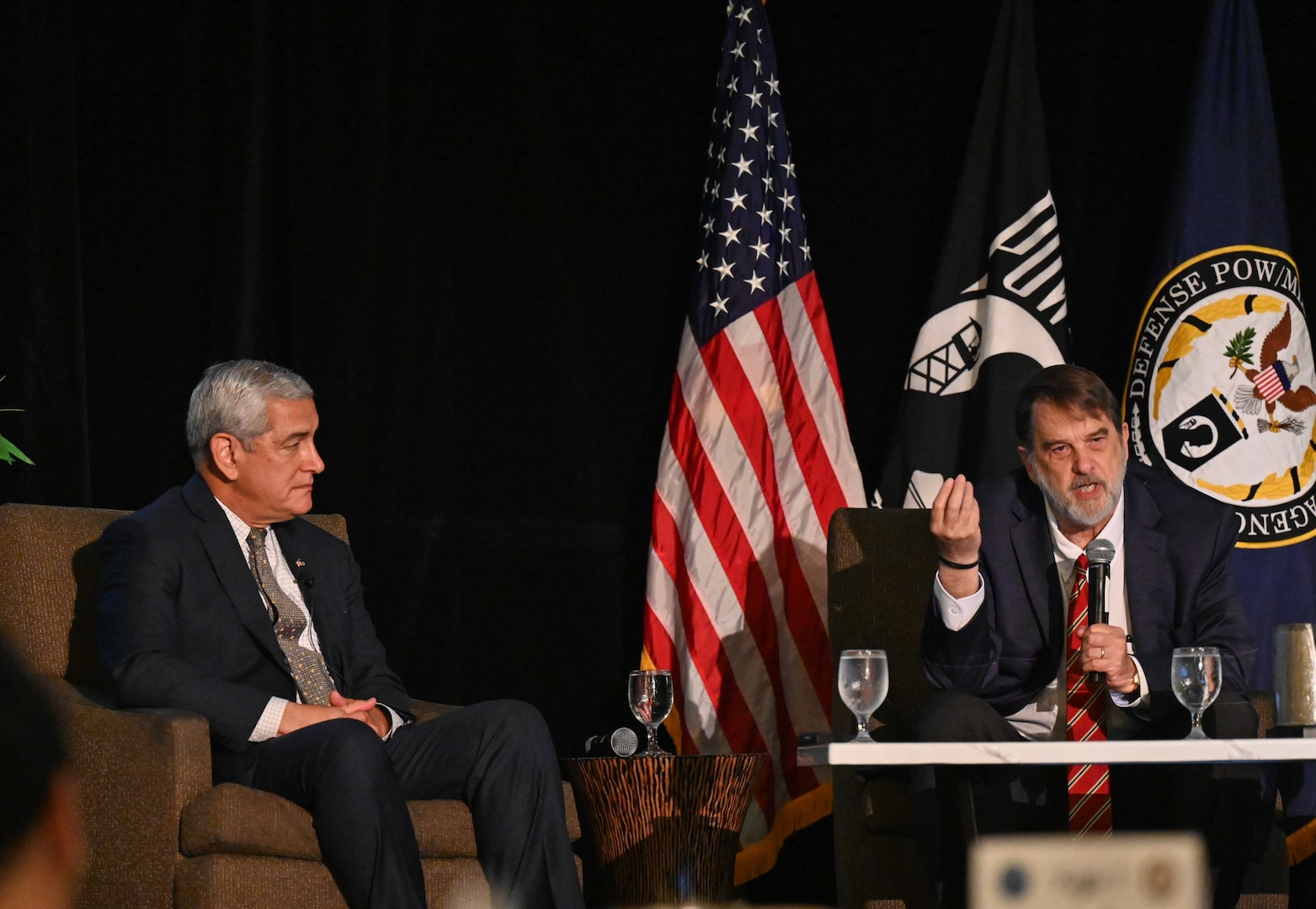 Kelly McKeague, Defense POW/MIA Accounting Agency director, left, and Dr. Tom Holland, research professor and director of the Forensic Institute for Research and Education at Middle Tennessee State University, right, give a brief at the Vietnam War Annual Government Briefing, Omaha, Nebraska, June 26, 2025.