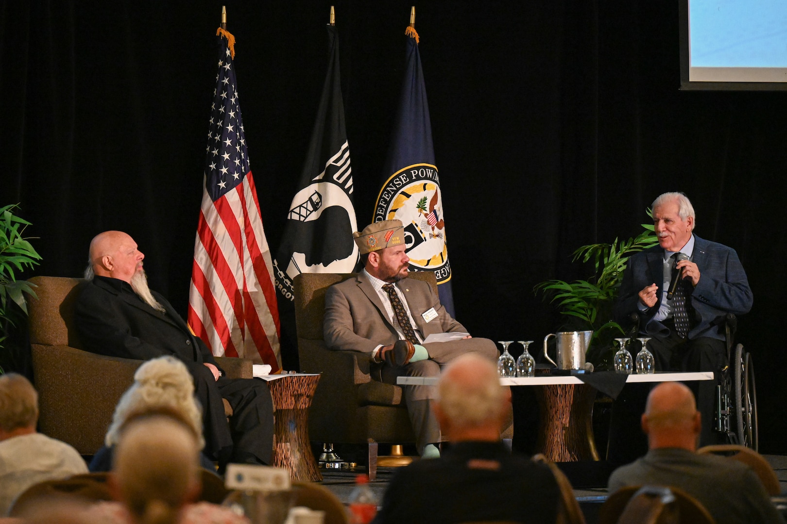 Gene Murphy, Disabled American Veterans, Department of South Dakota treasurer, right, Brian Walker, Veterans of Foreign Wars adjutant general, middle, and Grant Coates, Vietnam Veterans of America POW/MIA committee chair, left, give a brief during the Defense POW/MIA Accounting Agency's Vietnam War Annual Government Briefing, Omaha, Nebraska, June 27, 2025.