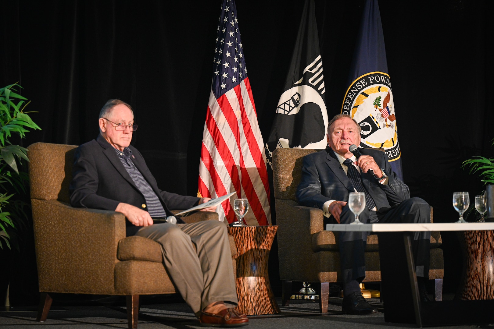 Retired U.S. Navy Capt. Lundquist, left, and Johnnie Webb, Vietnam War veteran and former Outreach and Communications deputy director, right, give a brief at the Vietnam War Annual Government Briefing, Omaha, Nebraska, June 26, 2025.