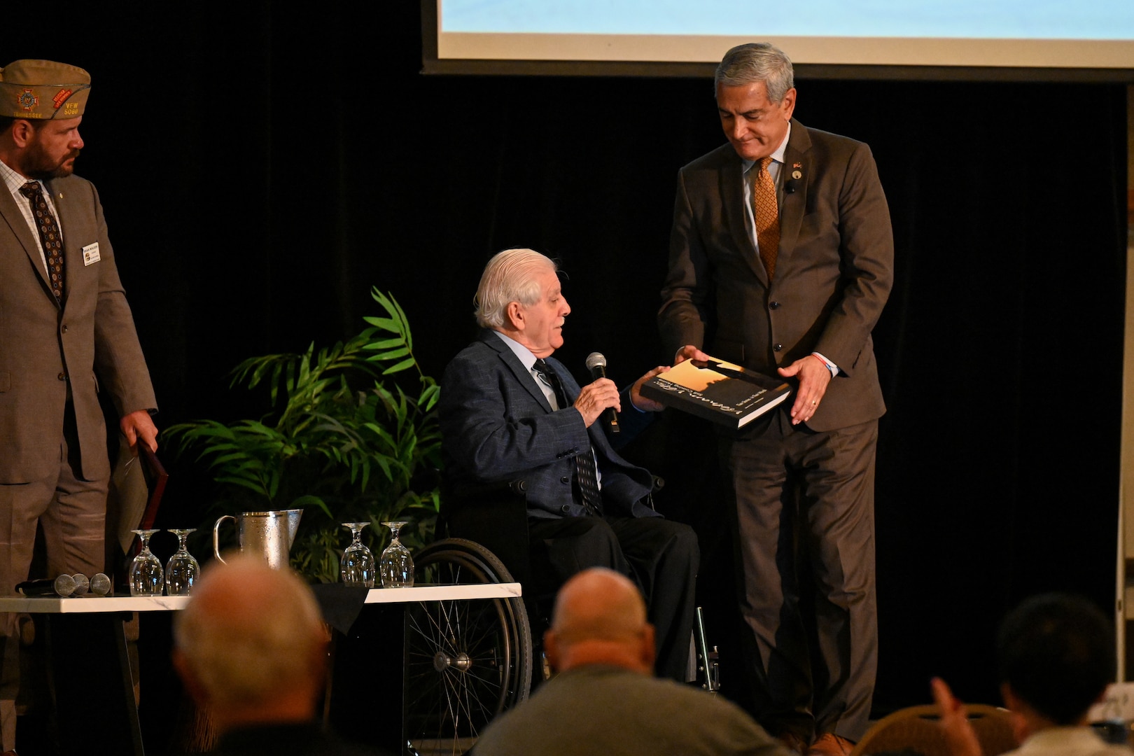 Gene Murphy, Disabled American Veterans, Department of South Dakota treasurer, presents Kelly McKeague, Defense POW/MIA Accounting Agency director, with a token of appreciation at DPAA's Vietnam War Annual Government Briefing, Omaha, Nebraska, June 27, 2025.