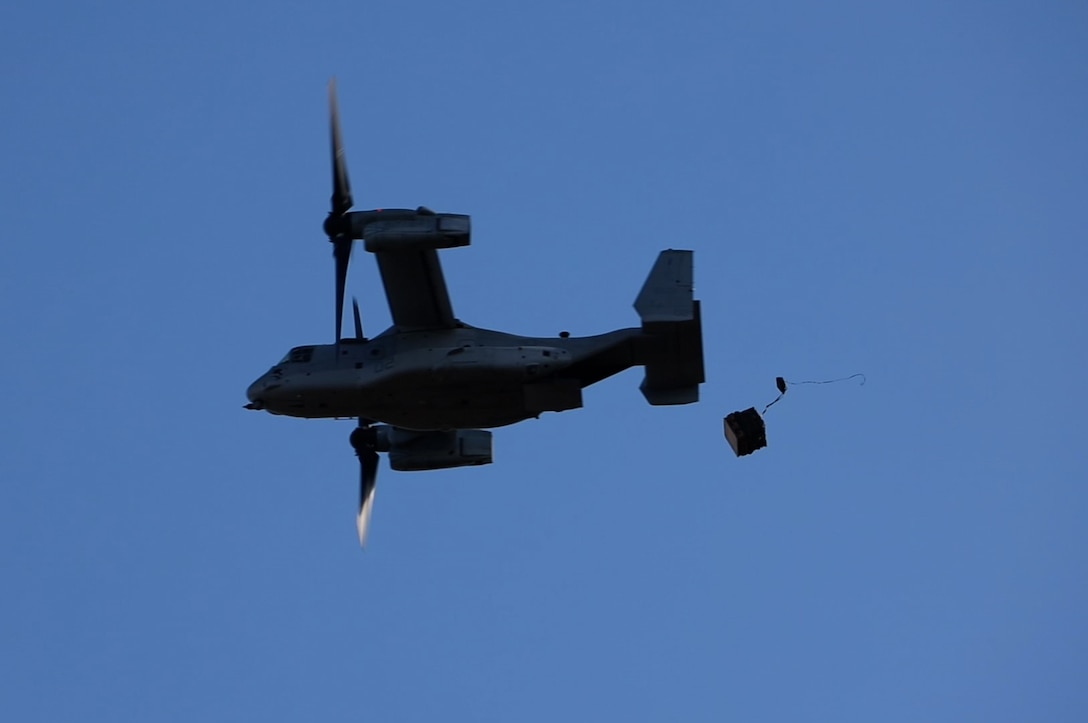 A U.S. Marine Corps MV-22B Osprey assigned to Marine Medium Tiltrotor Squadron (VMM) 265 (Rein.), 31st Marine Expeditionary Unit, conducts a low altitude air delivery during air delivery operations training at Kapyong drop zone, Williamson Airfield, Australia, June 25, 2025. Marines showcased their capabilities in rapid, expeditionary logistics, a critical skill for maintaining readiness in the Indo-Pacific region. The 31st MEU is operating aboard ships of the USS America Amphibious Ready Group in the 7th Fleet area of operations, the U.S. Navy’s largest forward-deployed numbered fleet, and routinely interacts and operates with allies and partners in preserving a free and open Indo-Pacific region. (U.S. Marine Corps photo by Lance Cpl. Gerardo Mendez)