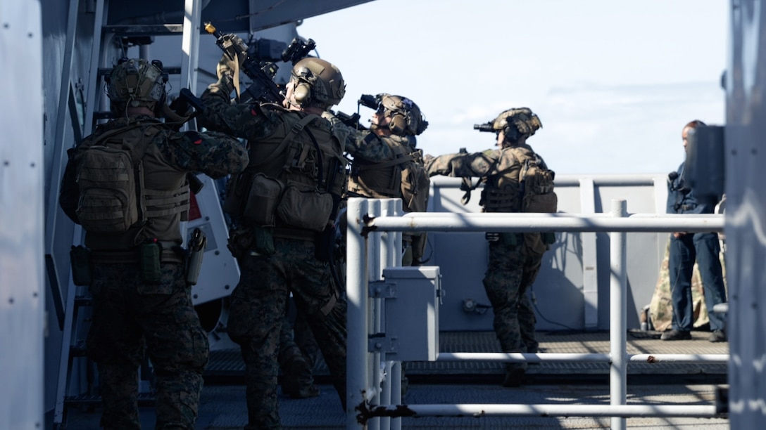 U.S. Marines with Force Reconnaissance Platoon, Maritime Raid Force, 31st Marine Expeditionary Unit, search the vessel during a visit, board, search and seizure exercise aboard the amphibious dock landing ship USS Rushmore (LSD 47), in the Coral Sea, June 28, 2025. VBSS is part of the maritime interception operations that aim to delay, disrupt, or destroy enemy forces or supplies in the maritime domain. The 31st MEU is operating aboard ships of the USS America Amphibious Ready Group in the 7th Fleet area of operations, the U.S. Navy’s largest forward-deployed numbered fleet, and routinely interacts and operates with allies and partners in preserving a free and open Indo-Pacific region. (U.S. Marine Corps photo by Cpl. Alora Finigan)