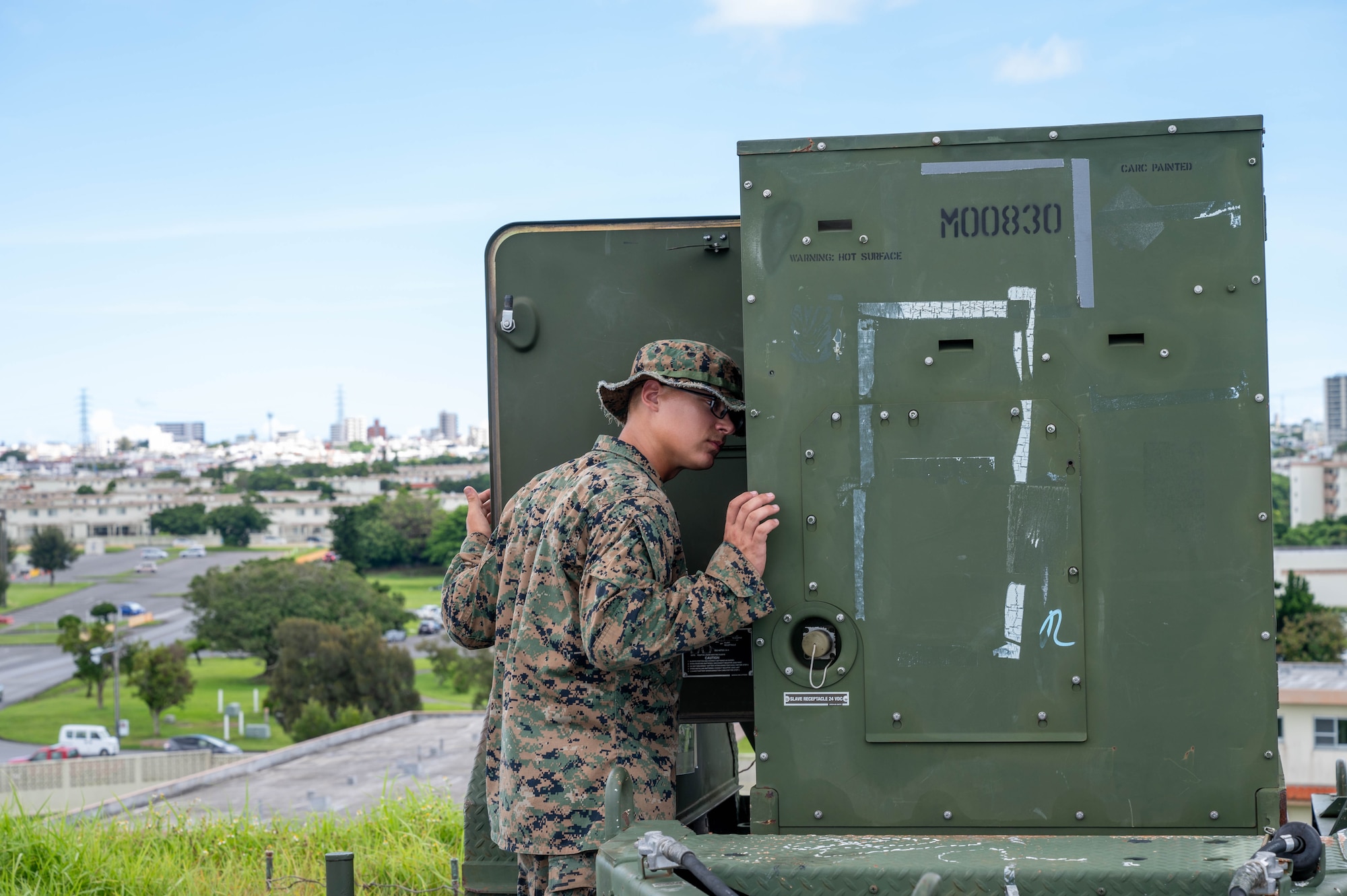 Service member inspects generator.