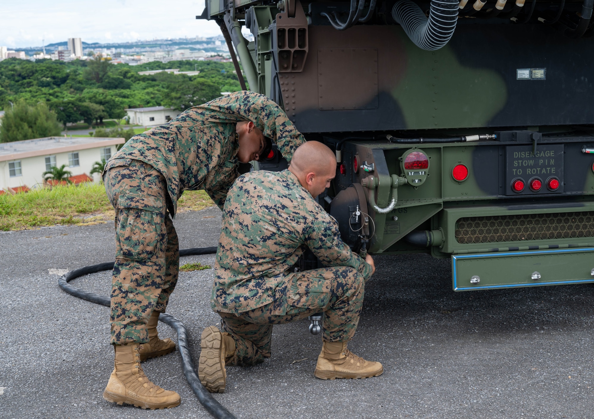 Service members disassembles radar.