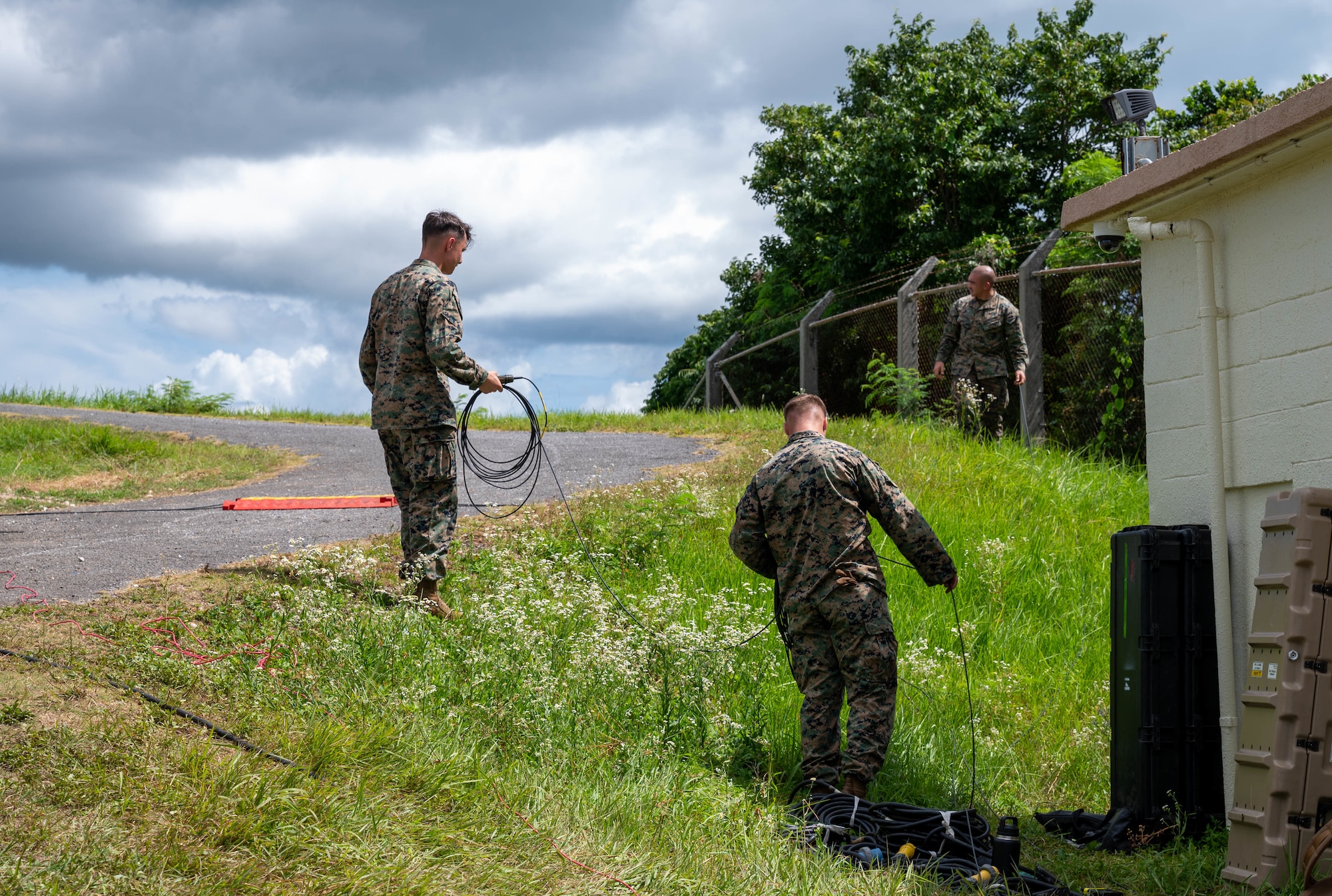 Service members cleaning up cables.