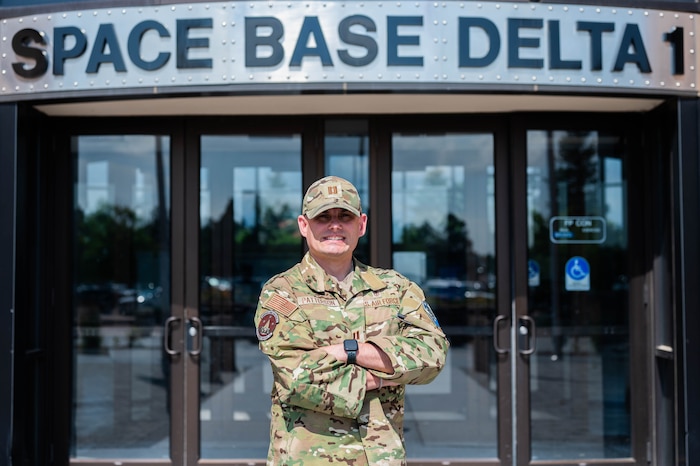 Capt. Ian Patterson poses for a photo in front of the Space Base Delta 1 headquarters building at Peterson Space Force Base.