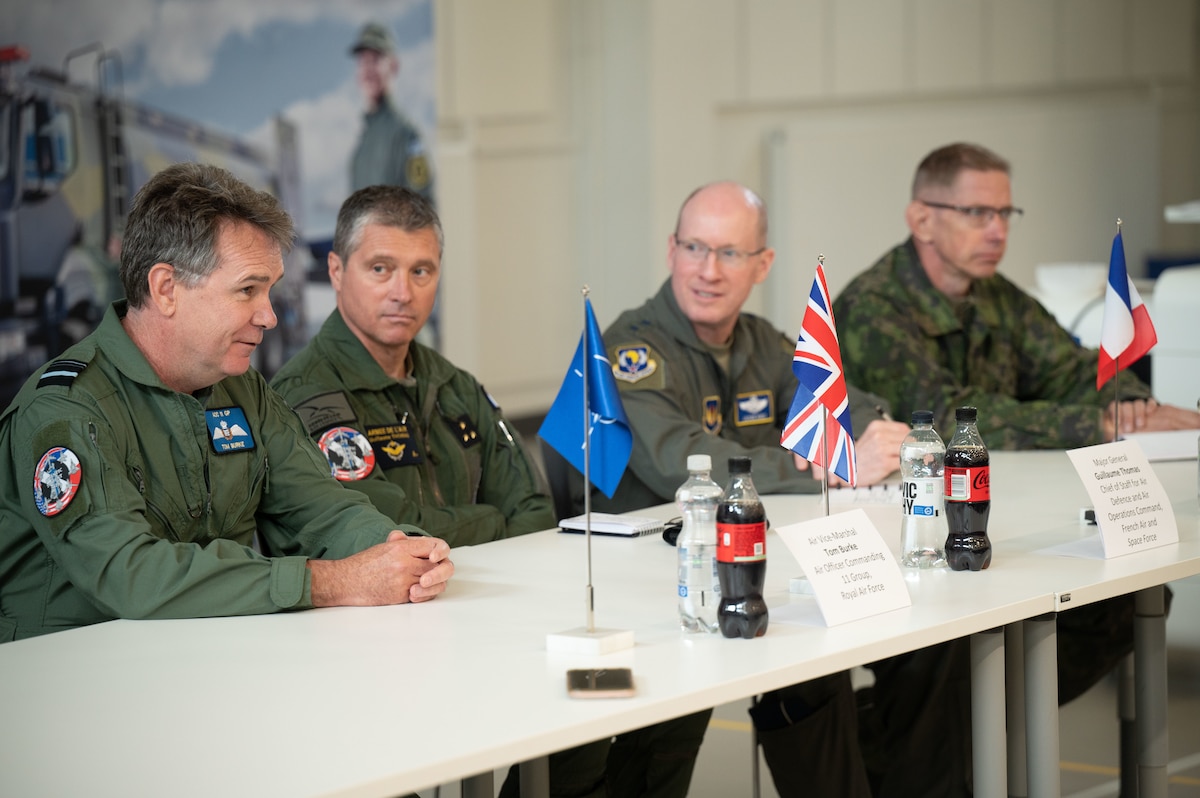 From left, Royal Air Force Air Vice Marshall Tom Burke, Air Officer Commanding 11 Group, French Air and Space Force Maj. Gen. Guillaume Thomas, Air Defense and Air Operations chief of staff, U.S. Air Force Lt. Gen. Jason Hinds, U.S. Air Forces in Europe - Air Forces Africa deputy commander, and Finnish Air Force Maj. Gen. Timo Herranen, Commander of the Finnish Air Force, discusses exercise Atlantic Trident 25 mission successes at Pirkkala Air Base, Finland, June 26, 2025. AT 25 focused on integrated operations with NATO Allies to ensure the Alliance is capable of projecting lethality and readiness throughout the European area of responsibility. (U.S. Air Force photo by Senior Airman Ashley Talley)